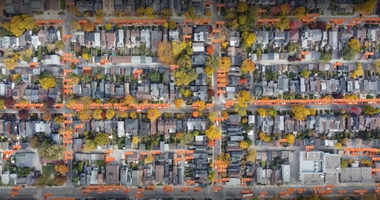 Birds-eye view of city streets with markers for each vehicle on the roadway.