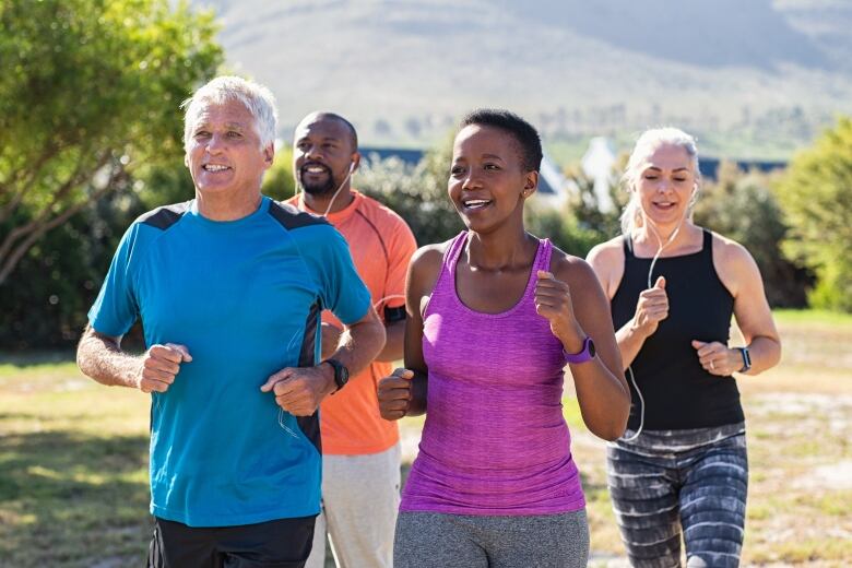 Four people in athletic clothing jog