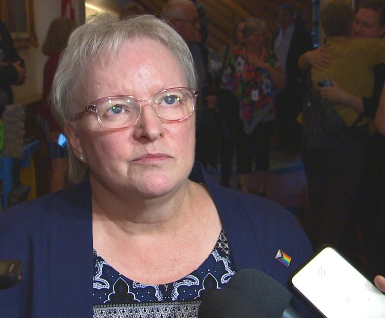 Woman surrounded by microphones