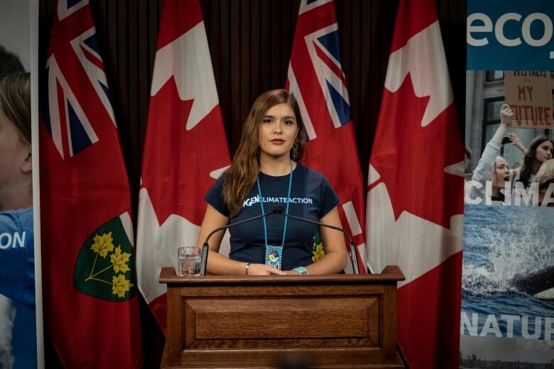 A woman at a podium for a news conference