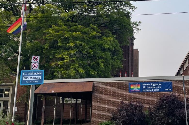 A school with a rainbow sign. 