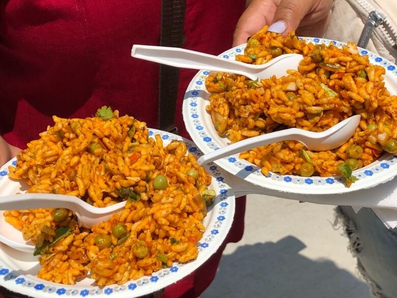 A spiced dish of puff rice, peas, red onions and cilantro