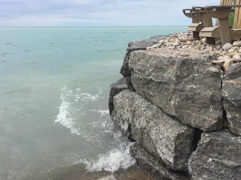 A curling wave hits a rock wall. 