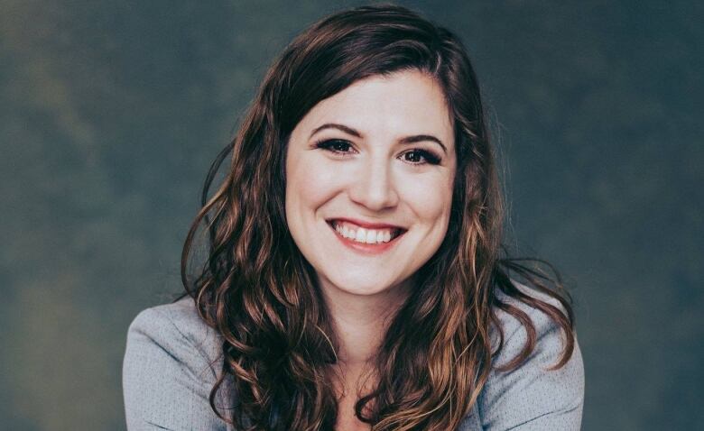 Woman with brown hair smiling at camera