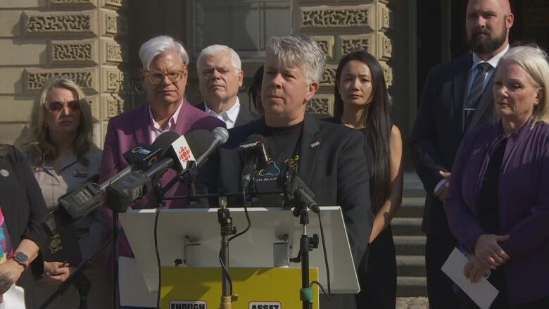 Ontario Public Services Employees Union (OPSEU) president JP Hornick stands at a podium outside of Osgoode Hall.