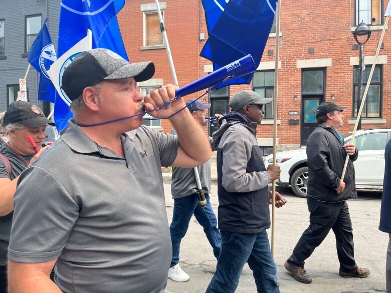 man blows a horn.