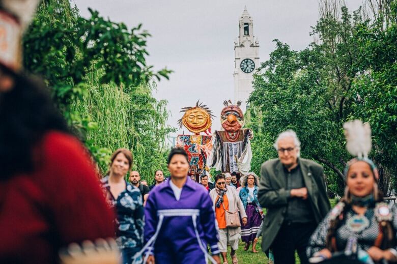 A crowd of people walking side by side. 