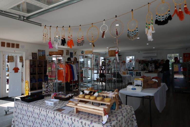 The inside of a small store, featuring dreamcatchers, jewelry and crafts.