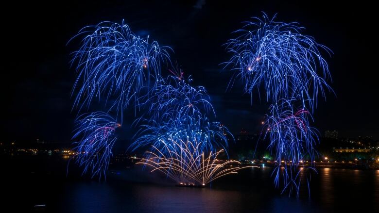 Blue fireworks against a night sky.