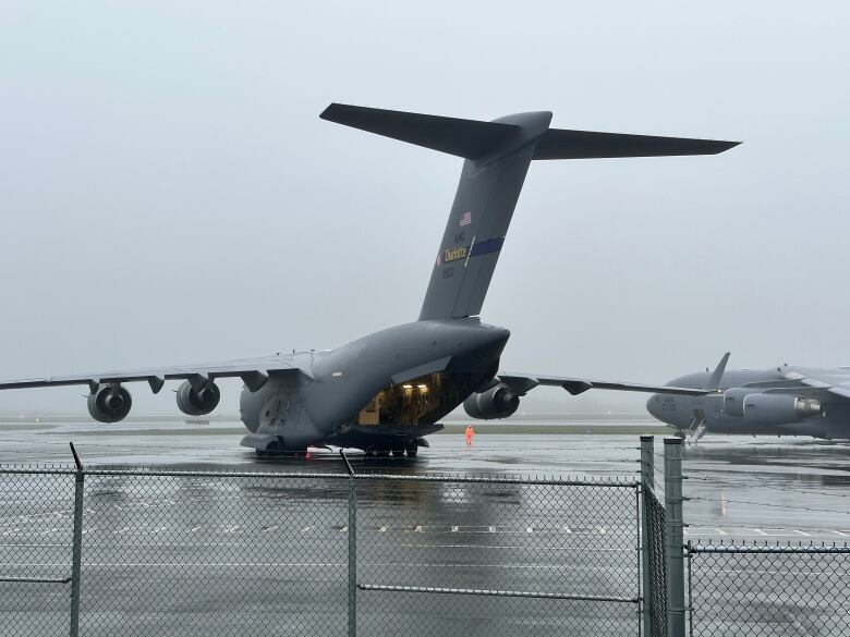 Two large aircraft sits on a runway.