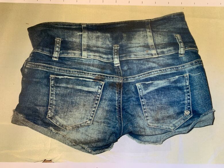 The victim's blue shorts were photographed by police during the autopsy.