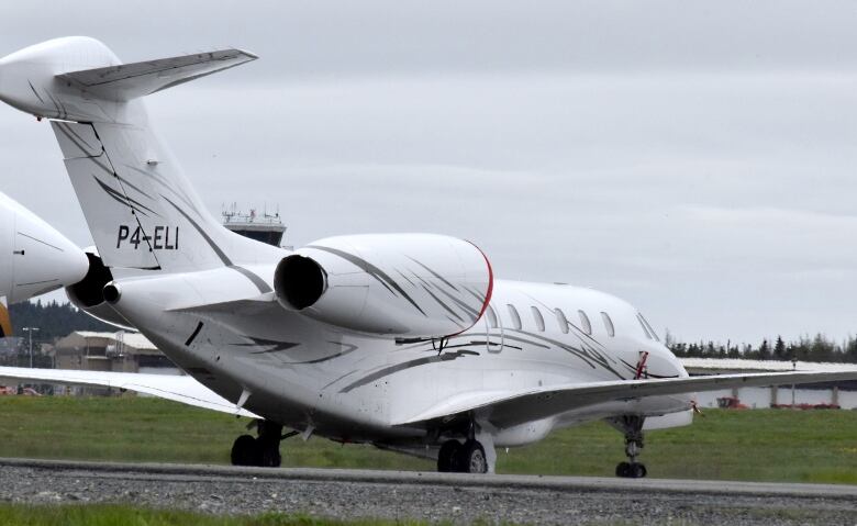 A small passenger plane is pictured by a field.