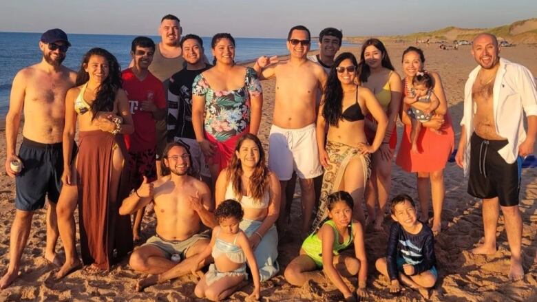 A group posing for a photo on a P.E.I. beach.