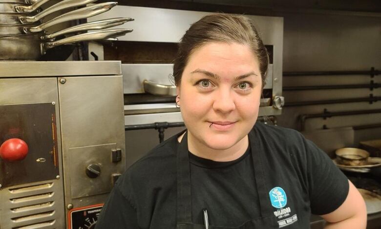 Chef Vita stands in her kitchen wearing a black shirt