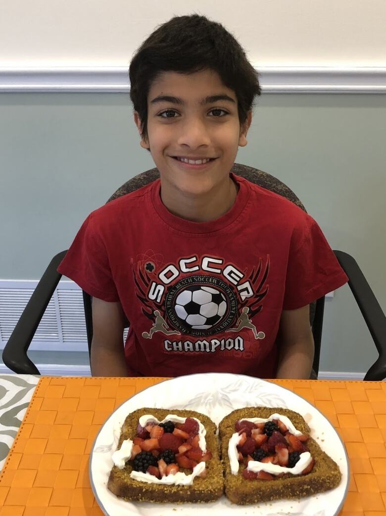 A young participant of the summerlunch+ program poses with the lunch he made. 