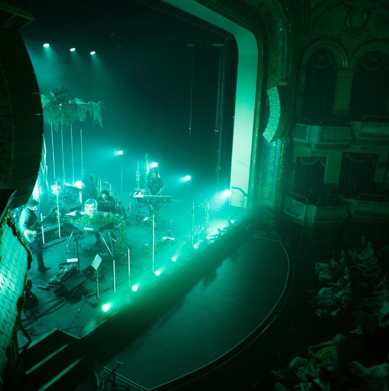 A band plays in an ornate theatre.