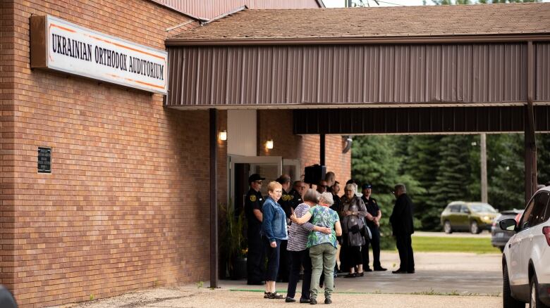 People gather outside a building.