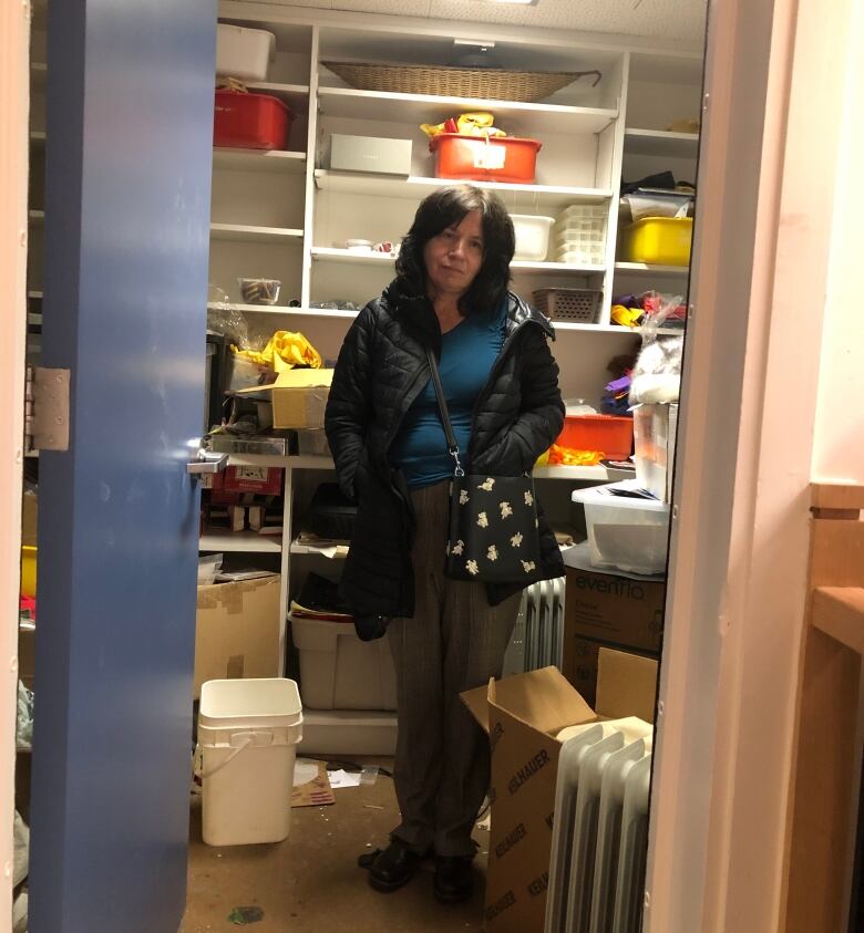 woman stands inside large closet