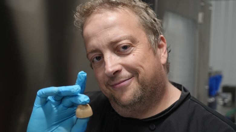 A man holding a piece of chocolate