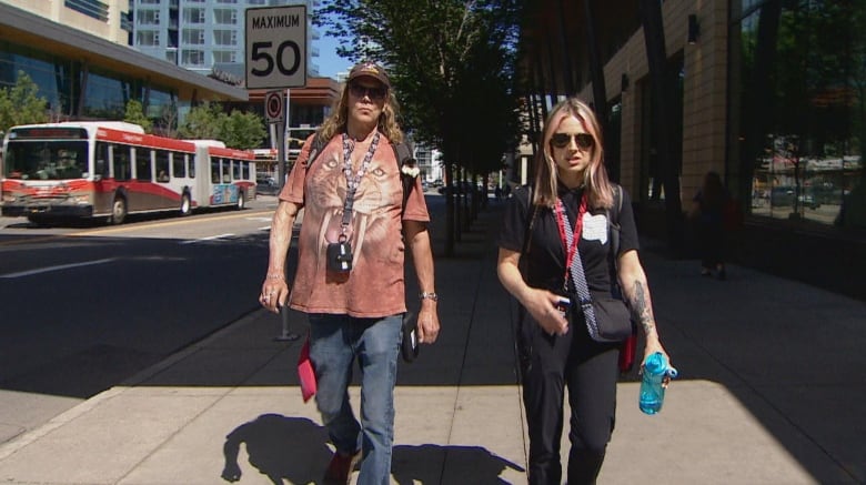 Two people walk in downtown Calgary.