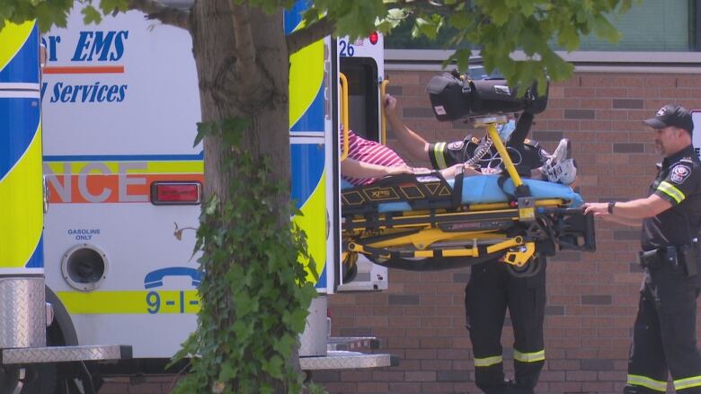 Paramedics bring a patient into Windsor Regional Hospital Ouellette Campus on June 19, 2023.