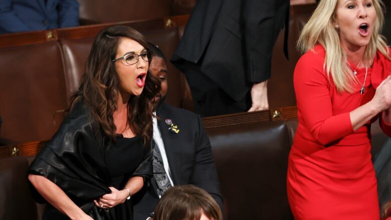 Two women standing and heckling