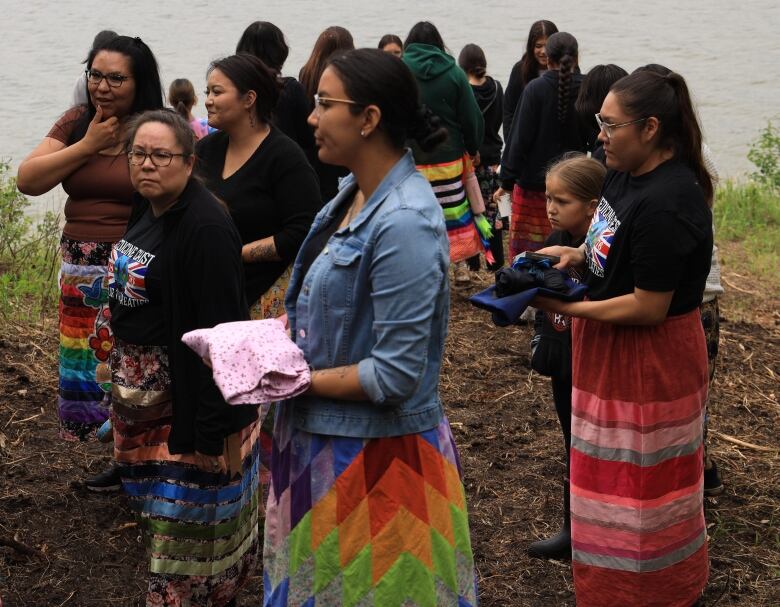 Doulas Charlene Gadwa (left) and Deanna Smith look on as mothers Chastity Gadwa-Quinney, Martina Desjarlais and Sequin Stanley hold their wrapped placentas. 