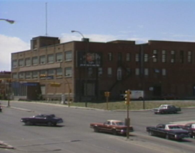 A warehouse building with a sign that says food bank above the door. 