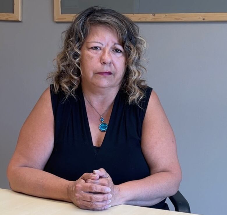 Cindy Pilz is pictured in a boardroom at Deaf and Hear Alberta.