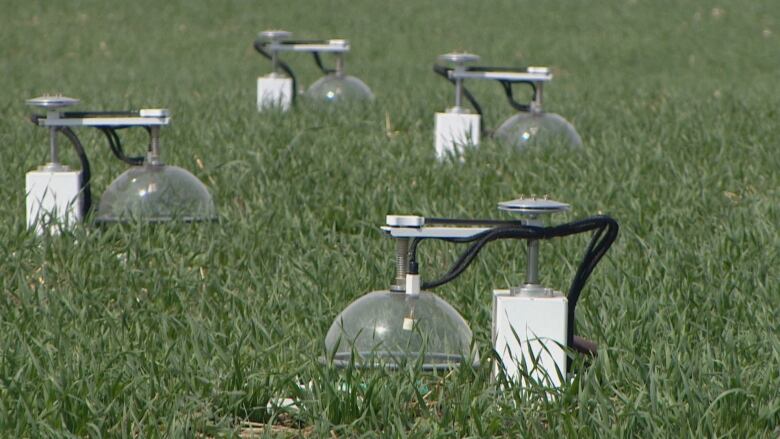 A system of machines on a field of grass.