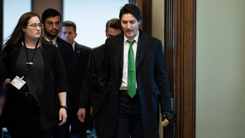 Prime Minister Justin Trudeau walks with members of his staff as he leaves a meeting of the Liberal Caucus on Parliament Hill in Ottawa, on Wednesday, March 8, 2023.