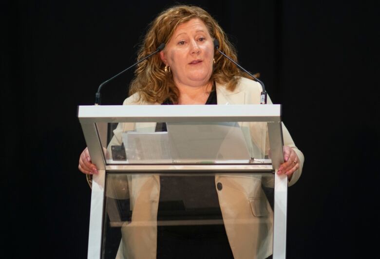 A woman standing at a podium.