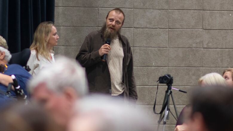 A man talking into a microphone.