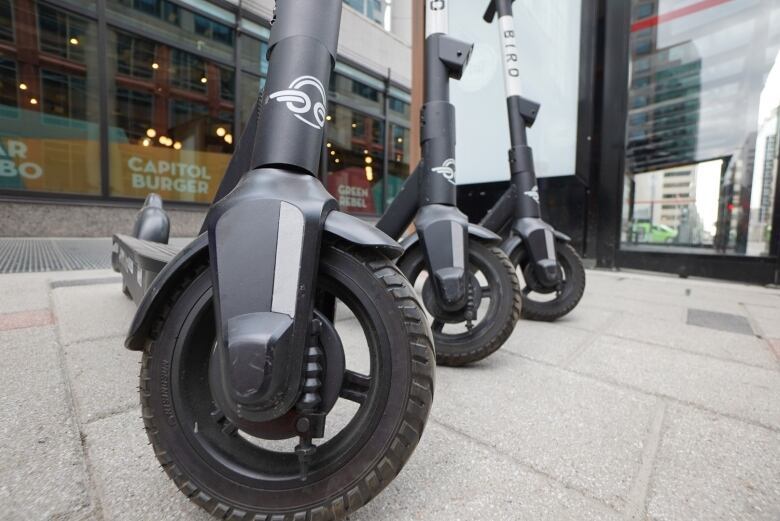 E-scooters on a sidewalk. 