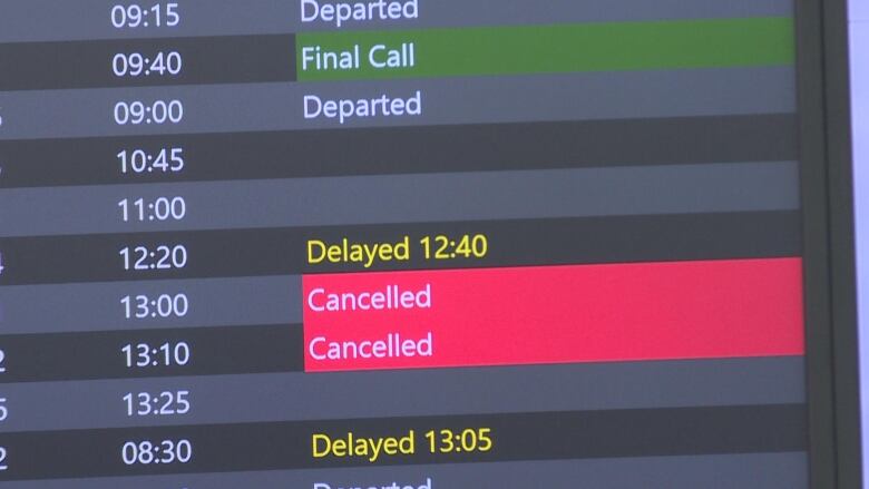 A screen at Calgary International Airport shows flights cancelled and delayed on June 28, 2023 following an hours-long outage a day earlier. 