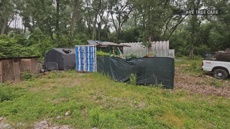 A shed with fencng around it.  