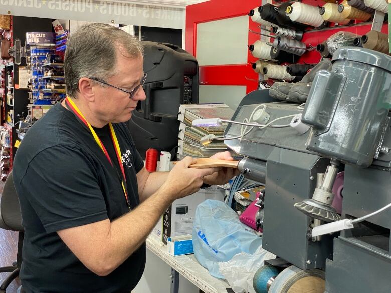 A man using an industrial sewing machine on a show.