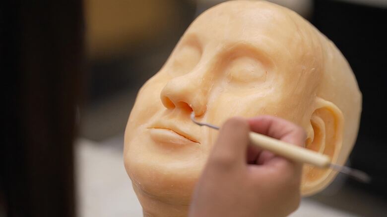 Close-up shot of a face created using wax at a restorative art class at Mount Royal University.