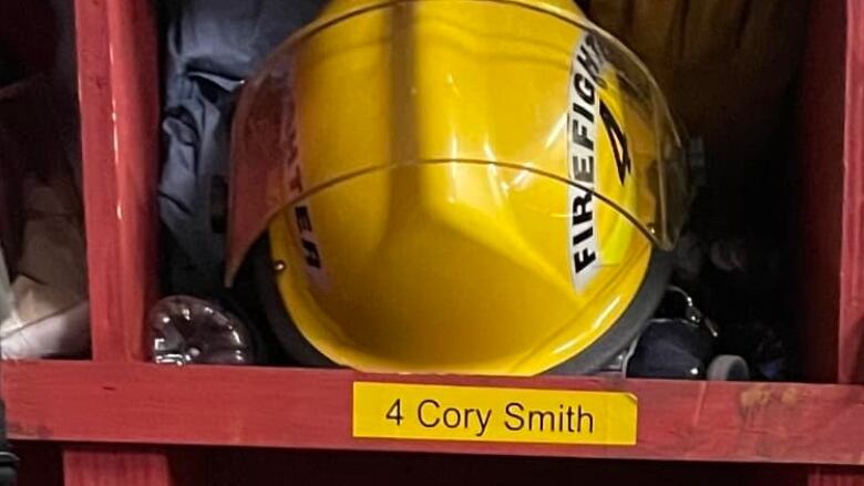 a photo of a firefighters' stall with a fire helmet and the name Cory Smith on the stall