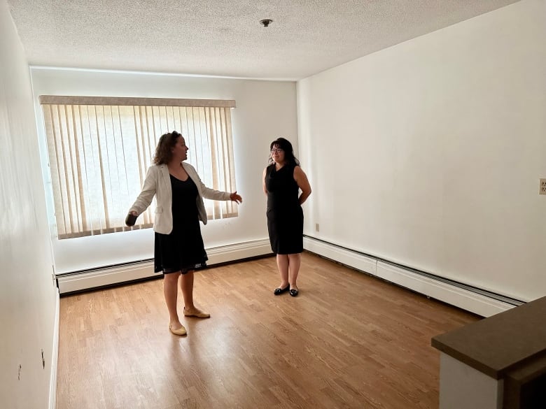 Yellowknife Mayor Rebecca Alty and N.W.T. Housing Minister Paulie Chinna stand in the living room of an apartment inside the Aspen Apartments. 