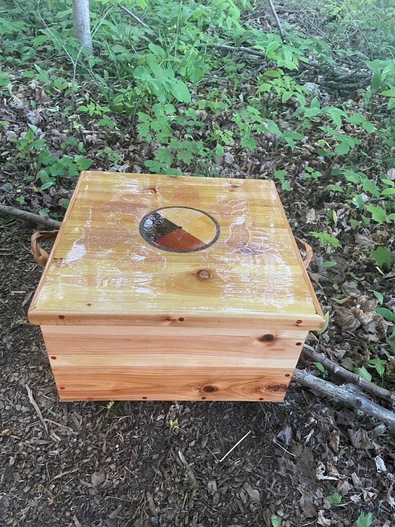 wooden box with medicine wheel on top