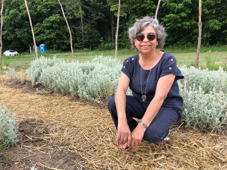 woman sits in garden