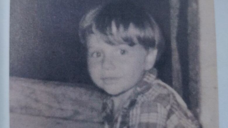 A black and white photo of a little boy.