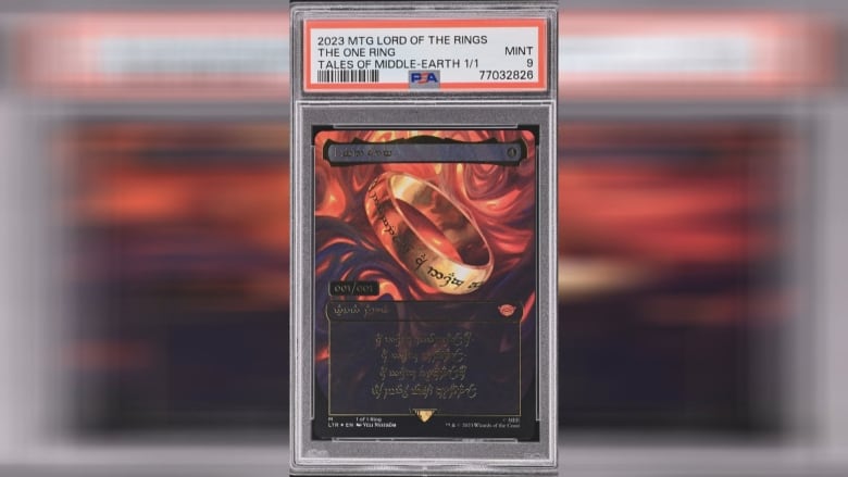 A game card with a gold ring and fire, the card is in a case with a label and barcode at the top.