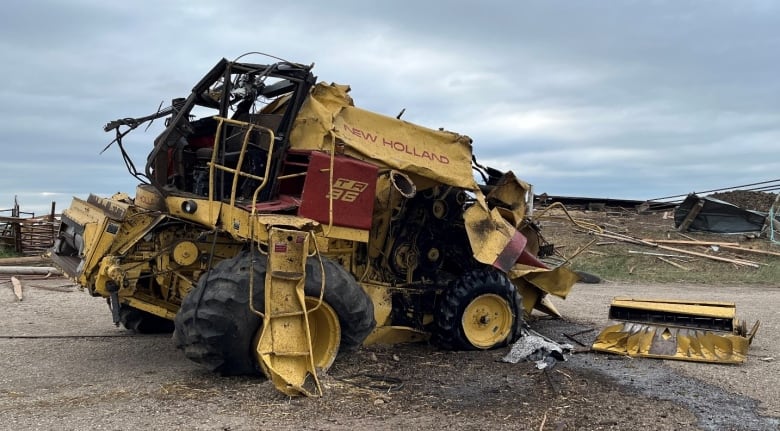 This nearby 10,000 km combine was lifted by the tornado and tossed about 50 metres, the damage survey report said. 