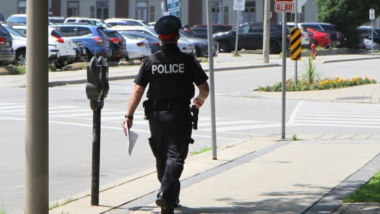 Police officer walks down street