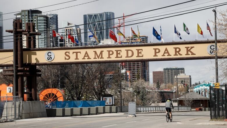 A biker is shown riding into deserted rodeo grounds.