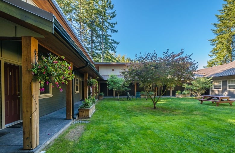 A building with an inner courtyard with trees and flowers.