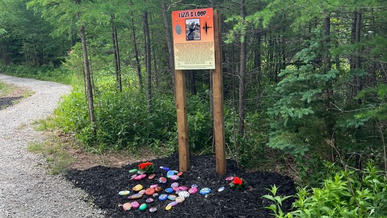 A trail head is shown near and elementary school with a plaque honouring a deceased classmate. 