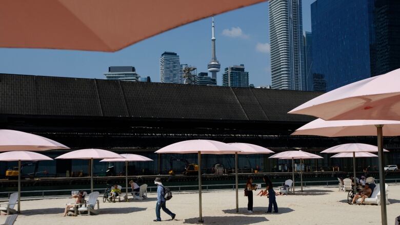 People are photographed at Sugar Beach in Toronto, on July 4, 2023. 